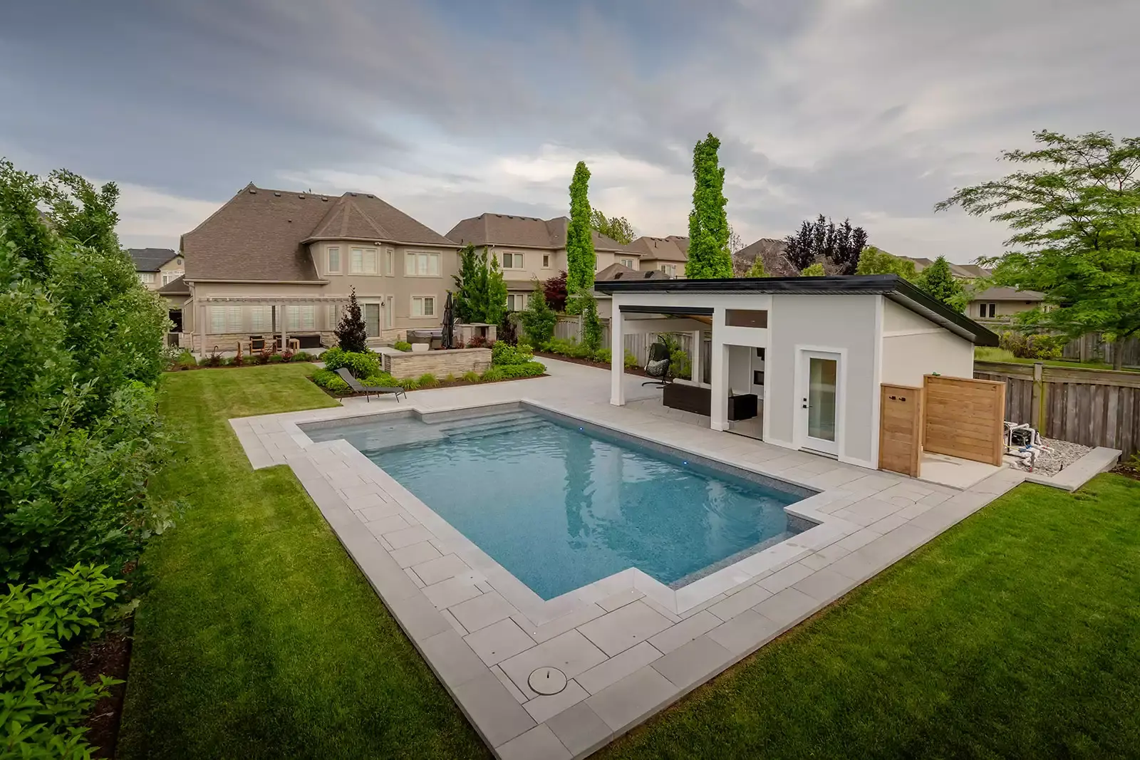 Natural stone patio and pool at dusk